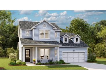 Charming two-story home with light blue siding, a front porch, and a well-manicured lawn at 215 Denham St, Summerville, SC 29486