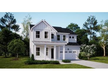 Charming two-story home featuring a white exterior, covered porch, and attached two-car garage at 221 Yalton St, Summerville, SC 29486