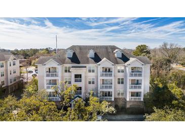 Attractive four-story condo building featuring private balconies and manicured landscaping at 2244 Ashley Crossing Dr # 1232, Charleston, SC 29414