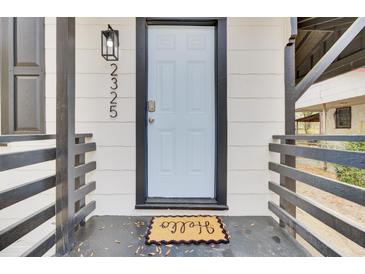Charming front entrance with a white door, black accents, and a welcoming 'Hello' doormat at 2325 Sorentrue Ave, North Charleston, SC 29405