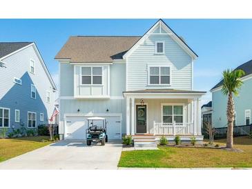 Charming light blue two-story home with a front porch, garage, and driveway with golf cart at 2951 Clearwater Dr, Mount Pleasant, SC 29466
