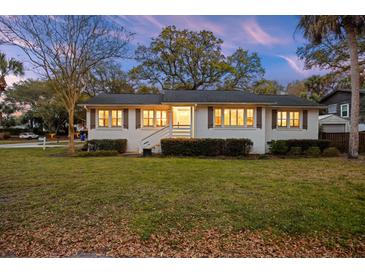 Charming single story home with a lush front lawn and beautiful trees at 3304 Hartnett Blvd, Isle of Palms, SC 29451