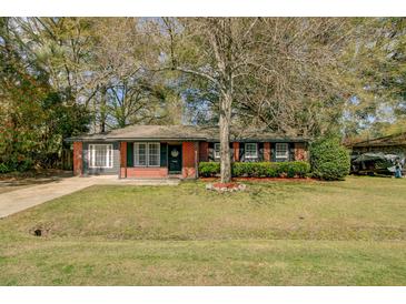 Charming single-story brick home with a well-maintained front yard and mature tree at 4418 Hardwood St, Ladson, SC 29456