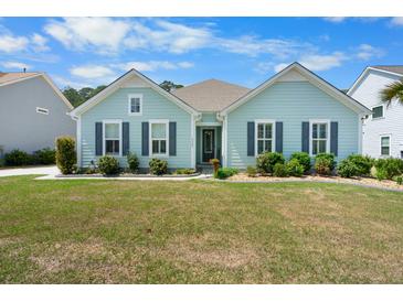 Charming one-story home with an inviting exterior, well-manicured lawn, and beautiful landscaping at 5509 Alpine Dr, Summerville, SC 29483