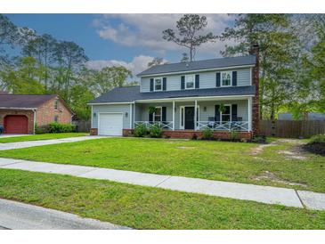 Charming two-story home featuring a covered porch, attached garage, and a well-manicured lawn at 106 Dunmow Dr, Summerville, SC 29485