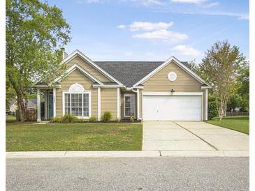 Charming single-story home with a well-manicured lawn and a two-car garage at 1537 Sweet Myrtle Cir, Mount Pleasant, SC 29466