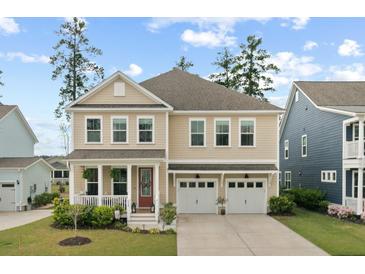 Charming two-story home featuring a welcoming front porch and a two-car garage at 154 Calm Water Way, Summerville, SC 29486