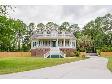 Charming two-story home with a large front porch and well-maintained lawn at 187 Pecan Dr, Summerville, SC 29483