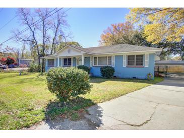 Charming single-story home with a well-manicured lawn and driveway at 1925 Belgrade Ave, Charleston, SC 29407
