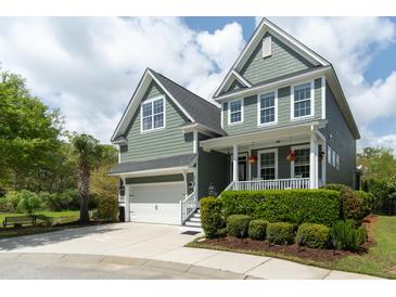 Charming two-story home with green siding, front porch, and well-manicured landscaping at 2160 Pentland Dr, Charleston, SC 29412