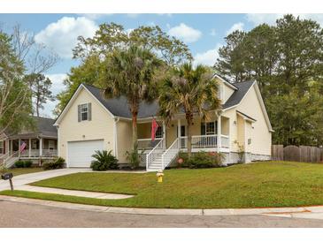 Charming yellow two-story home with front porch, palm trees, and well-manicured lawn at 225 Hanahan Plantation Cir, Hanahan, SC 29410