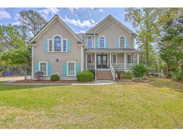 Charming two-story home featuring an inviting front porch, well-manicured lawn, and classic architecture at 3805 Adrian Way, Mount Pleasant, SC 29466