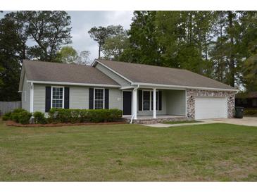 Charming single-story home with light gray siding, black shutters, and a well-manicured lawn at 708 Old State Rd, Goose Creek, SC 29445