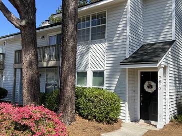 Charming two-story home with a manicured lawn and welcoming front door at 7870 Nummie Ct, North Charleston, SC 29418