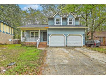 Charming two-story home with blue siding, double garage, and inviting front porch at 107 Lewisfield Dr, North Charleston, SC 29418