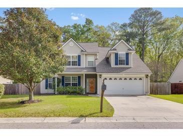 Charming two-story home featuring a manicured lawn and attached two car garage at 119 Oakbluff Rd, Summerville, SC 29485