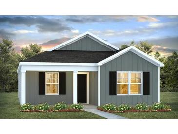 Charming single-story home with gray siding, black shutters, and well-manicured lawn, perfect for modern living at 131 River Hill Rd, Goose Creek, SC 29445