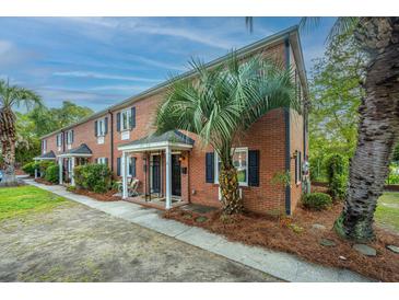 Charming brick townhomes with black shutters and mature palm trees offering curb appeal at 21 Hester St # Apt 12, Charleston, SC 29403