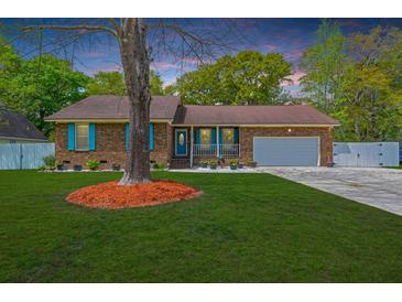 Charming brick home with blue shutters and a well-manicured lawn at 2233 Glendale Dr, Charleston, SC 29414