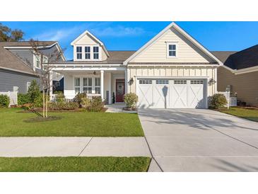 Charming home with a well-manicured lawn, white garage door, and inviting front porch at 3005 Aura Ln, Summerville, SC 29483