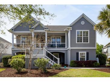 Charming two-story home featuring a covered front porch and beautifully landscaped front yard at 3558 Stockton Dr, Mount Pleasant, SC 29466