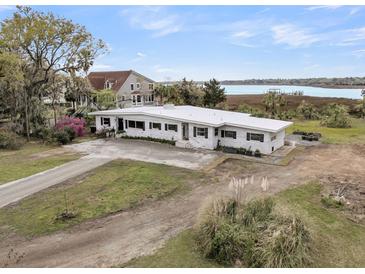 Stunning waterfront home featuring a clean design, beautiful landscaping, and serene water views at 4701 Apple St, North Charleston, SC 29405