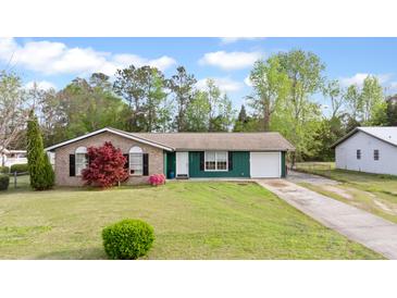Charming single-story home with brick and siding, a well-manicured lawn, and a convenient attached garage at 1003 Mountain Pine Rd, Moncks Corner, SC 29461