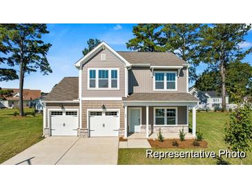 Charming two-story home with a manicured lawn, two car garage, and attractive curb appeal at 1007 Toland Dr # 45P, Saint George, SC 29477