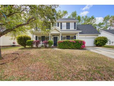Charming two-story home with landscaped yard and inviting curb appeal on a sunny day at 2019 Azalee Ln, Summerville, SC 29483