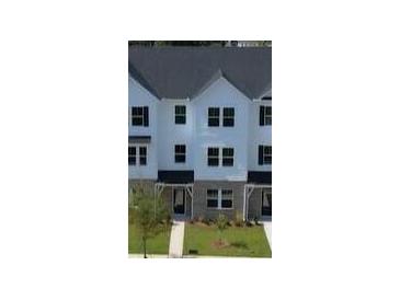 New construction townhouse with black shutters and sidewalk to the covered entry at 5108 Double Eagle Lp, Summerville, SC 29485