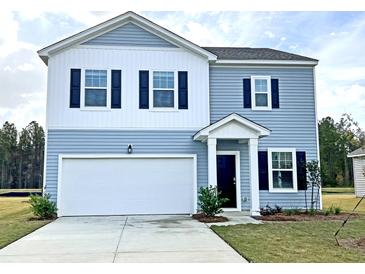 Charming two-story home with blue siding, white accents, and a two-car garage at 700 Pisces Ln, Summerville, SC 29486