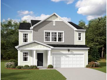 Charming two-story home featuring a two-car garage, black roof and a welcoming front porch at 707 Pisces Ln, Summerville, SC 29486