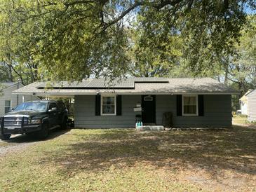 Charming single-story home featuring solar panels and a convenient carport for covered parking at 1206 Hawthorne Rd, Hanahan, SC 29410