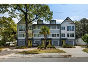 Contemporary townhome complex with garages and individual driveways, landscaped yards, and modern architectural design at 4060 S Rhett Ave, North Charleston, SC 29405