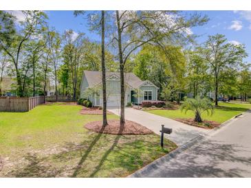 Charming single-story home with a well-manicured lawn and a lovely garden at 5560 Alpine Dr, Summerville, SC 29483