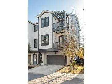 Beautiful three story home with dual balconies and gray two car garage at 1213 Gatch Ct, Mount Pleasant, SC 29464