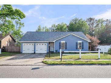 Charming blue single-story home with a two-car garage and well-maintained front yard at 188 Ponderosa Dr, Ladson, SC 29456