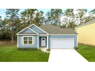 Charming one-story home with blue siding, white trim, and a well-manicured front lawn, perfect for first-time buyers at 2243 Macallan Blvd, Ravenel, SC 29470