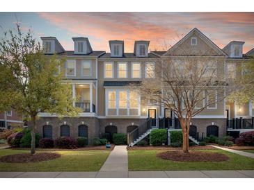 Charming townhome with brick accents, landscaped front yard, and inviting entryway at sunset at 2519 Rutherford Way, Charleston, SC 29414