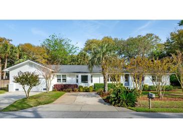 Charming one-story home with white exterior and well-manicured front yard landscaping at 3 Lauden Blvd, Isle of Palms, SC 29451