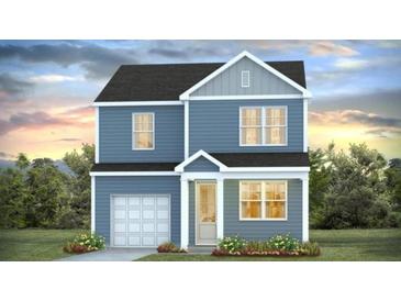 Charming two-story home featuring a covered porch, attached garage and manicured lawn at 335 Dickerson Ln, Lincolnville, SC 29485