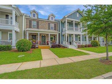 Charming multi-colored two-story townhomes with inviting front porches and well manicured lawns at 3466 Yarmouth Dr, Mount Pleasant, SC 29466