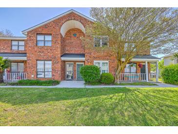 Charming brick townhome with well-manicured lawn and inviting front porch at 1421 Dove Run Dr # C, Charleston, SC 29412