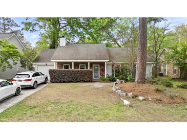 Charming single-story home with brick accents, mature landscaping, and a well-manicured front yard at 181 Commons Way, Goose Creek, SC 29445