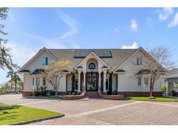 Stately home featuring a brick driveway, manicured lawn, and inviting facade with elegant columns at 1954 Sandy Point Ln, Mount Pleasant, SC 29466