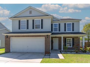 Charming two-story home featuring brick accents, a well-maintained lawn, and an attached two-car garage at 5007 Ballantine Dr, Summerville, SC 29485
