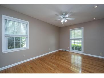 Bedroom features gleaming hardwood floors, modern ceiling fan, and dual windows at 100 Nighthawk Ln, Summerville, SC 29485