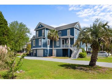 Charming blue two-story home with well-manicured lawn, stairs, and lush greenery offering curb appeal at 1188 Quick Rabbit Loop, Charleston, SC 29414