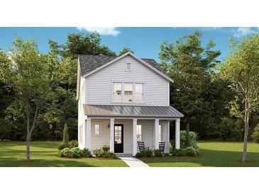 Charming two-story home with white siding, a covered porch, and rocking chairs at 130 Maritime Way, Summerville, SC 29485