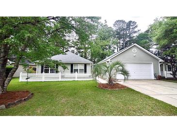 Charming single-Gathering home with well-manicured lawn, white picket fence, and two-car garage at 148 Jupiter Ln, Summerville, SC 29483